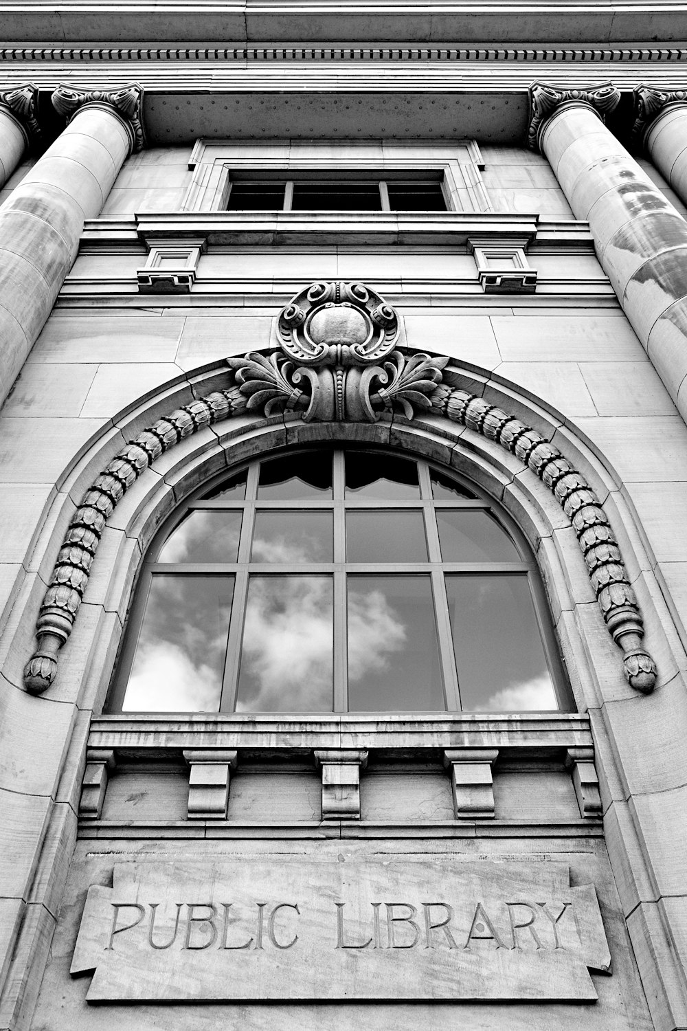 low-angle photography of Public Library arch window