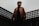 man standing on black fence