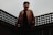 man standing on black fence