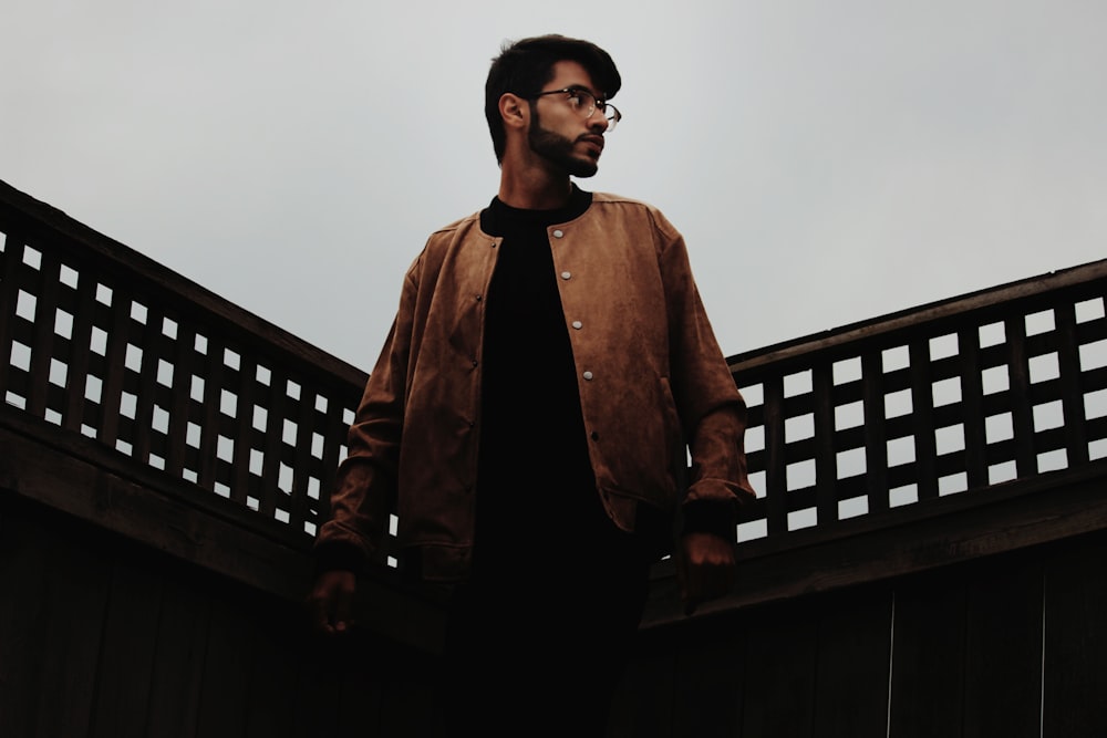 man standing on black fence