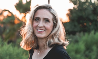 smiling woman in shallow focus photography