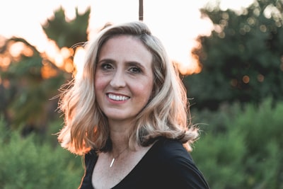 smiling woman in shallow focus photography mature google meet background