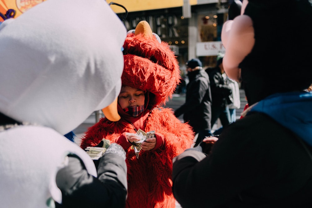 person counting money in Elmo costume