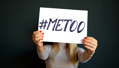 woman holding paper with metoo sign written