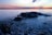 black rock surrounded with body of water