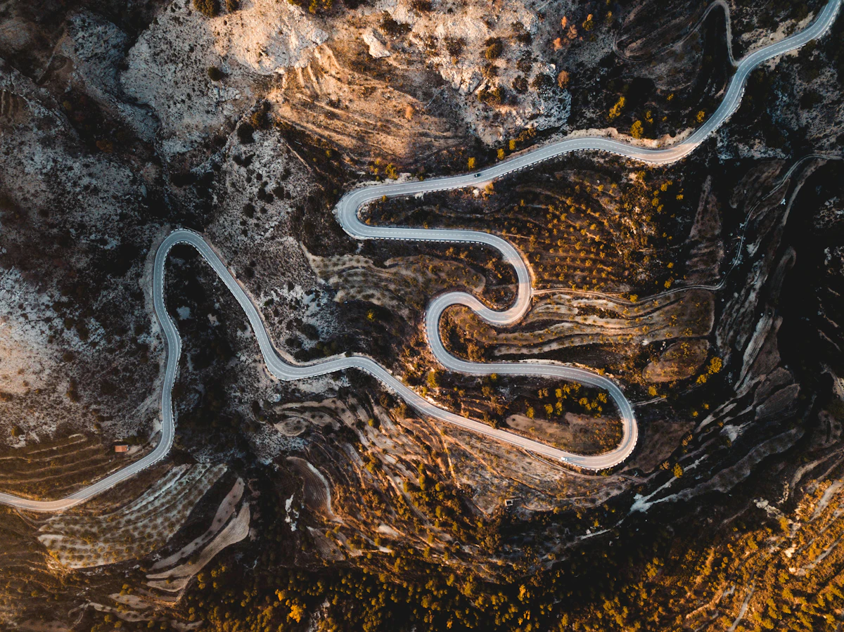 An aerial view of a road curving through the hills