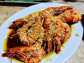A plated dish of garlic butter shrimp garnished with parsley, ready to enjoy