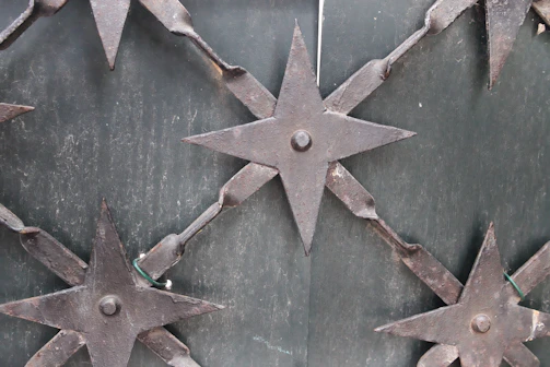 Detailed view of a stainless steel gate with modern geometric patterns
