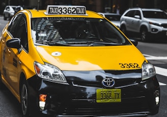 Toyota taxicab at the road in the city during day