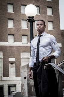 man holding black suit jacket