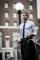 man holding black suit jacket