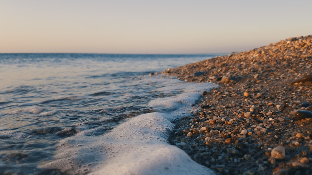 low angle photo of seashore under cloudy sky at daytime