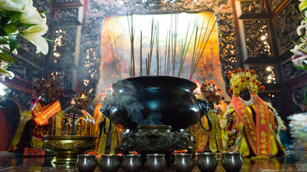 black cooking pot near flowers