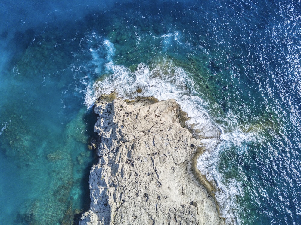 aerial view of stone beside body of water