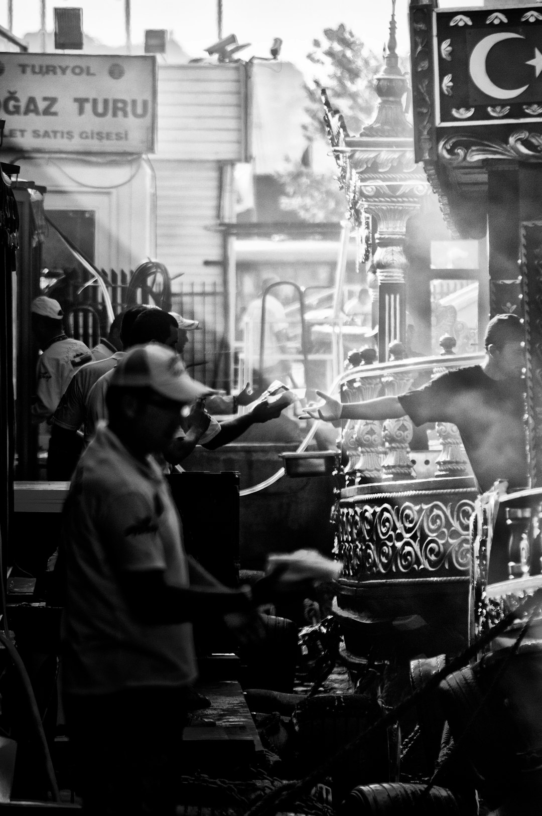 man giving man box in grayscale photography