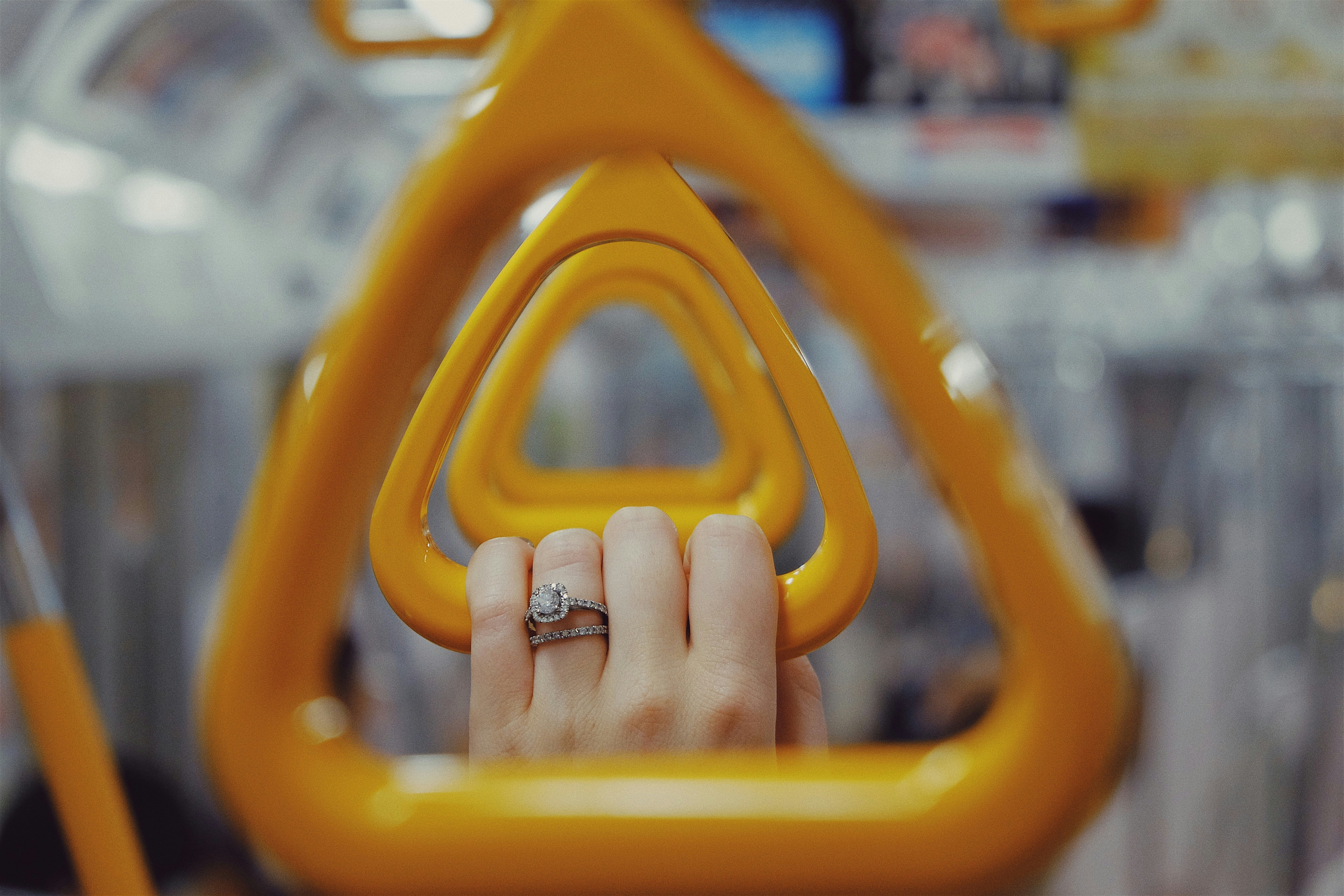 macro shot of yellow train hanging handles