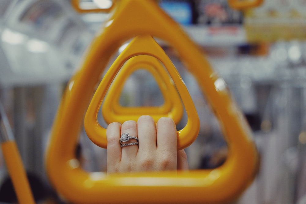 macro shot of yellow train hanging handles