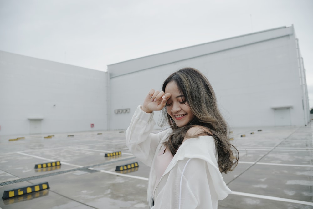 woman taking picture on parking lot during daytime