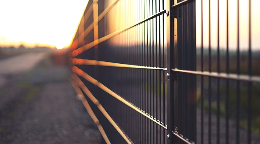 black metal fence during sunset