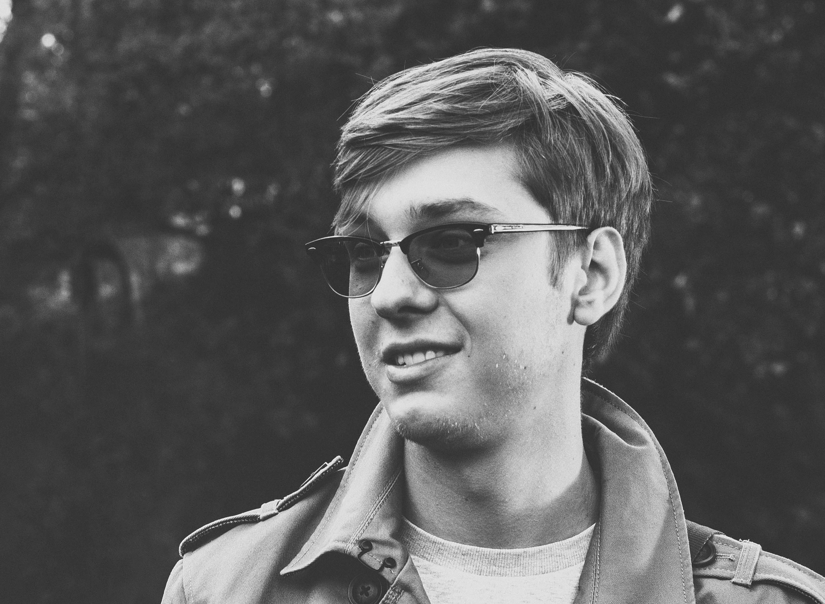 Young man with casual smile, outdoor portrait