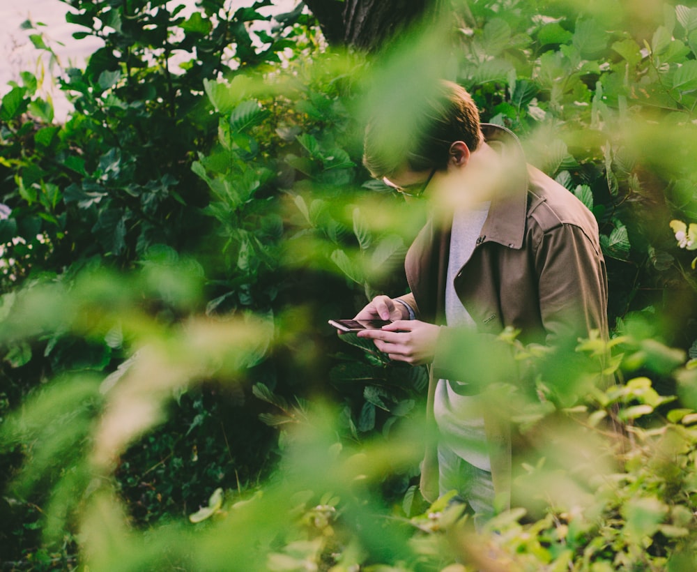 man in brown jacket while using jacket