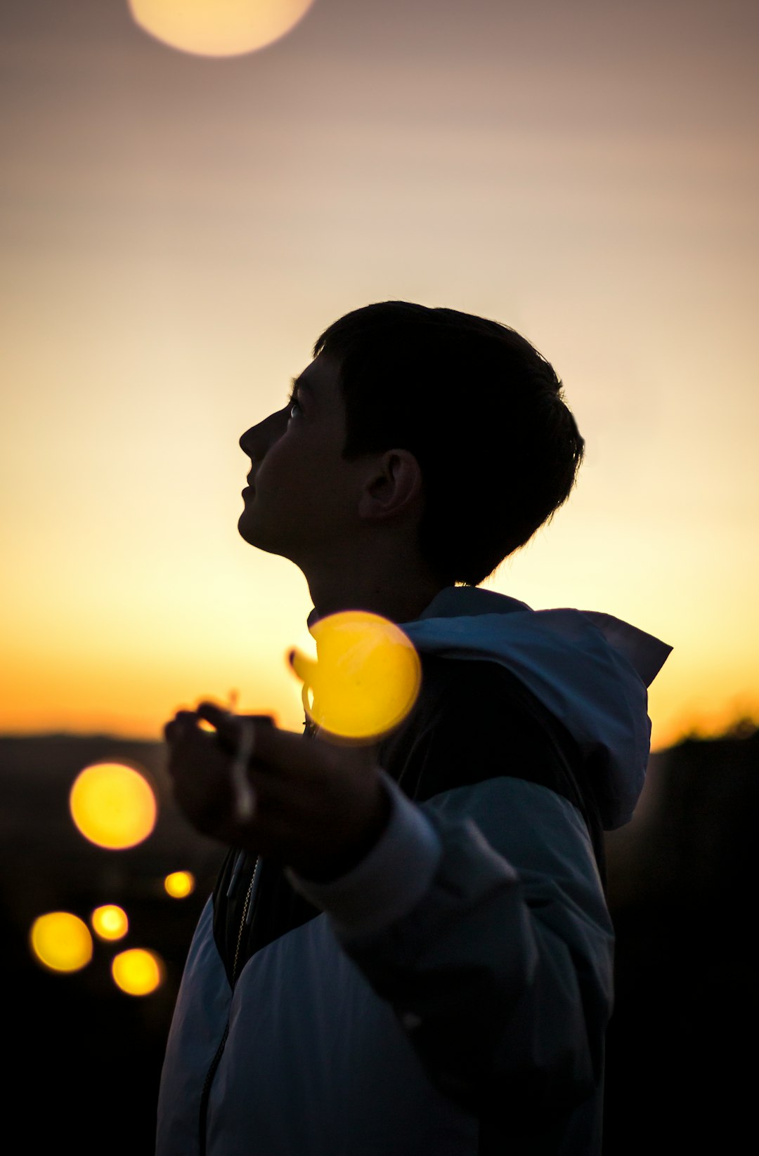 selective focus photography of person spread arms under golden hour