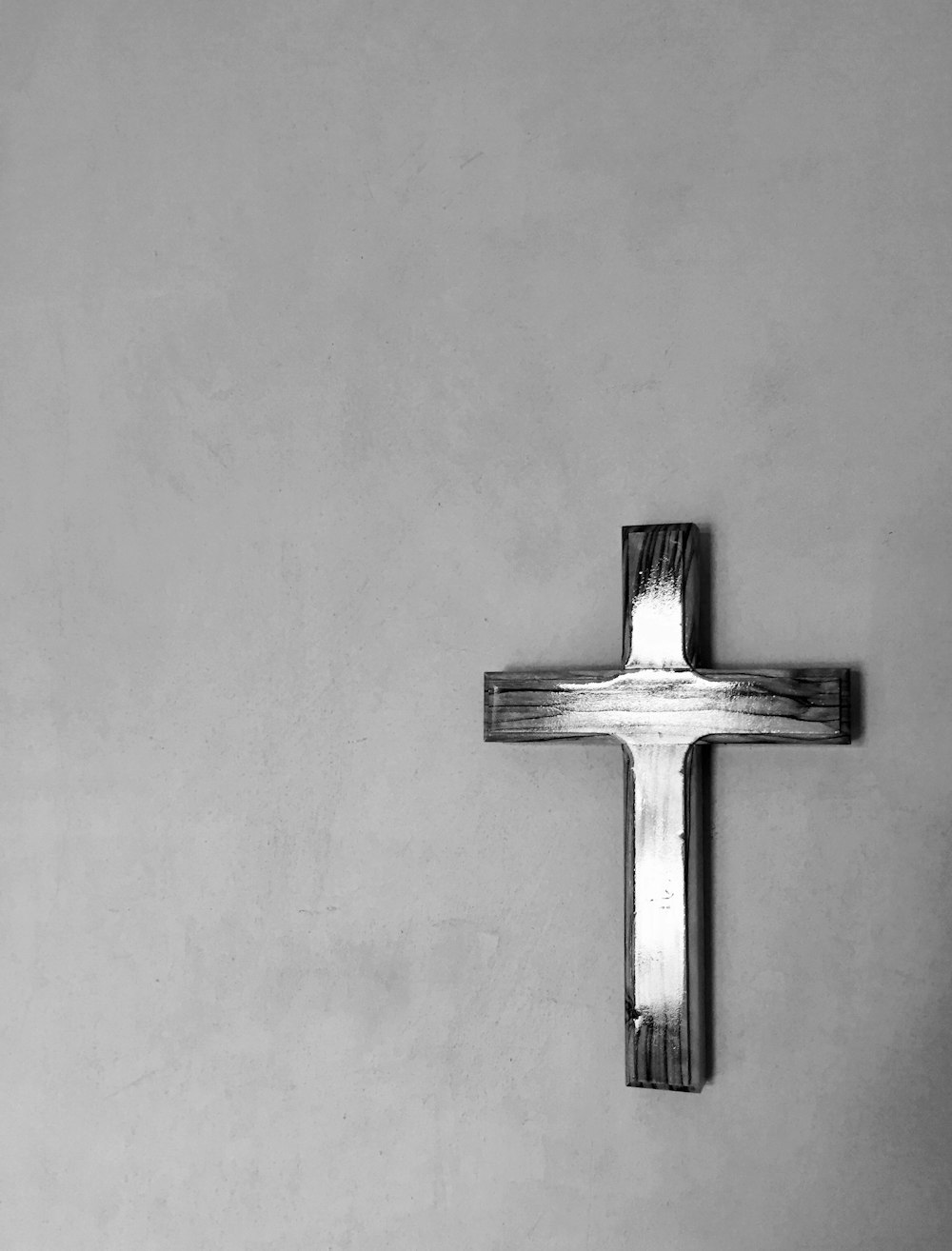cross mounted on gray painted wall