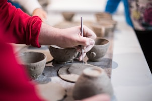 person doing clay containers
