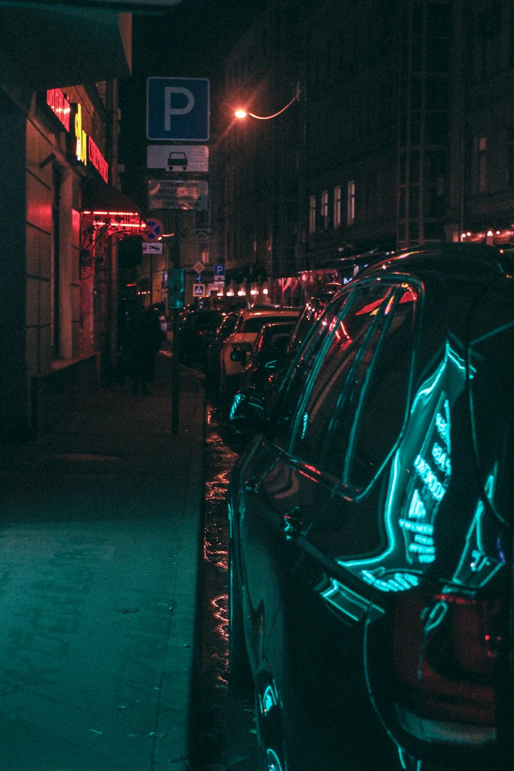 black vehicle parked near parking signage