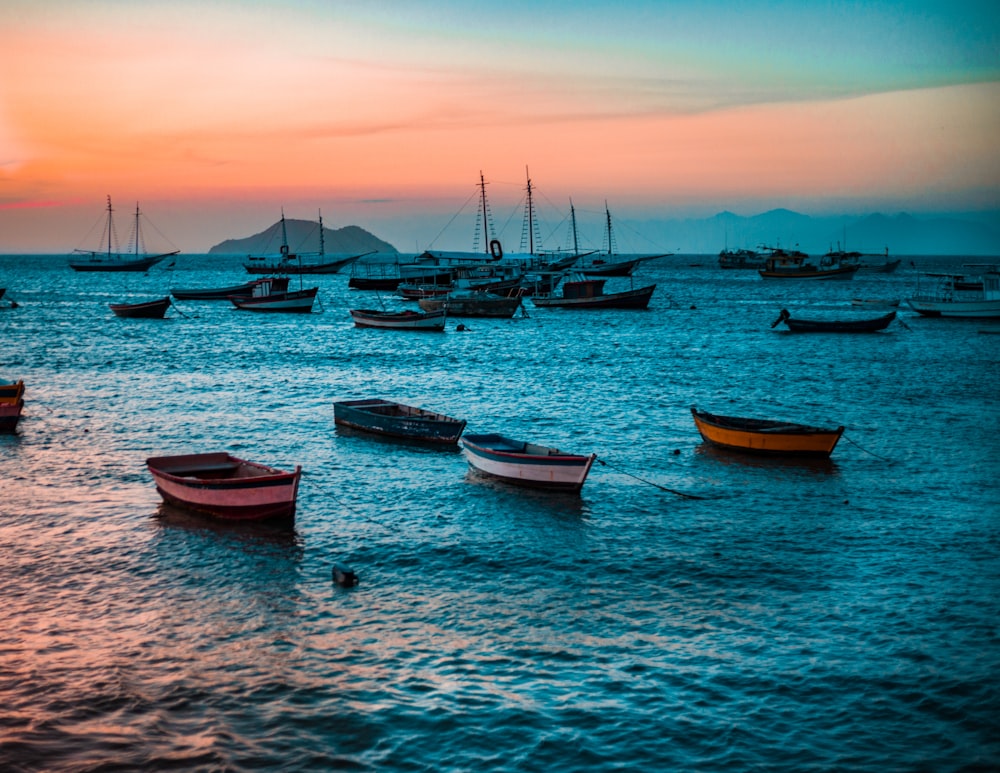 assorted-color wooden boat on body of water