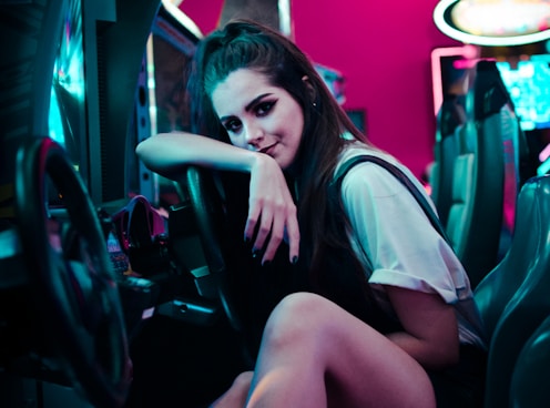 woman sitting on car arcade machine onlyfans