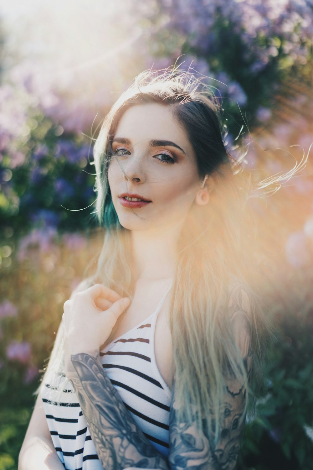 selective focus photography of woman wearing white and black striped spaghetti strap top