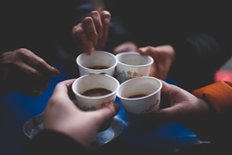 group of people holding mugs
