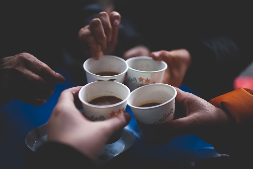 group of people holding mugs