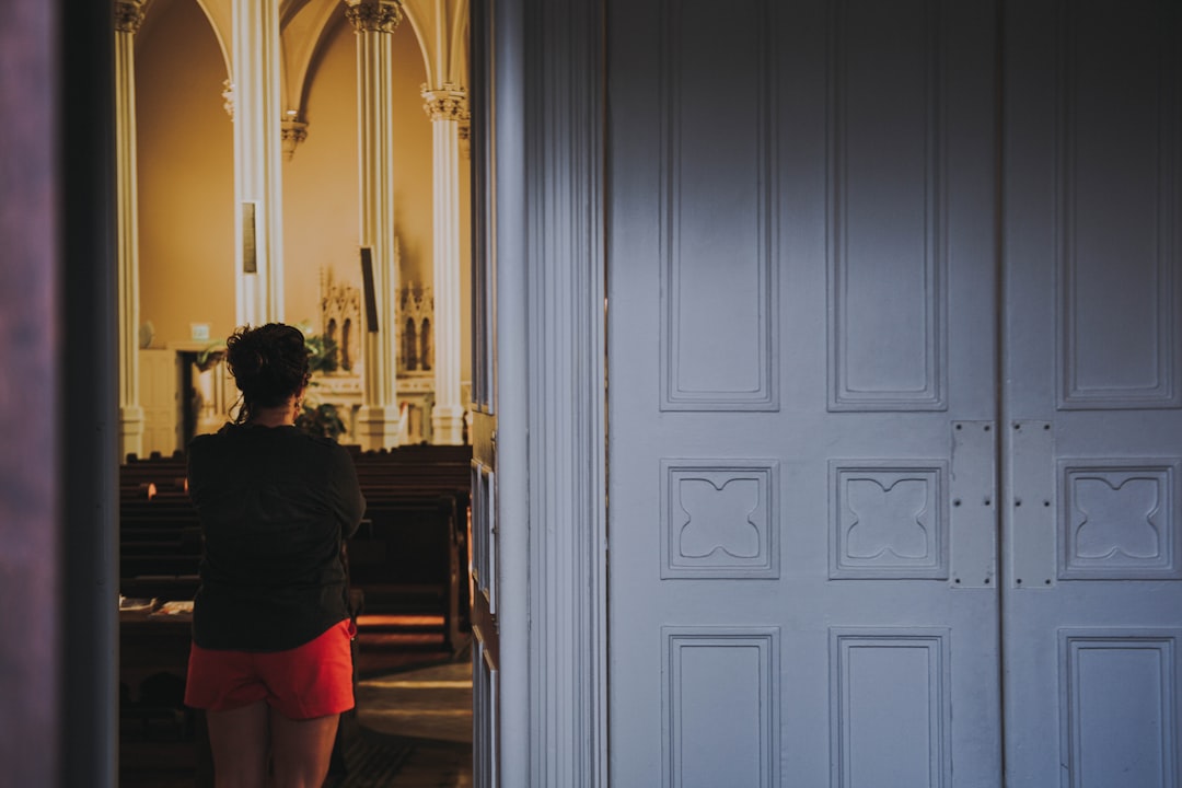 woman standing beside white door