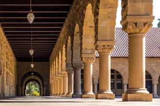brown concrete hallways with columns