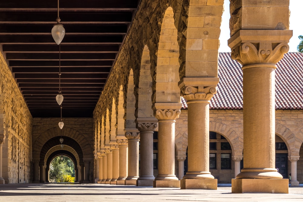 brown concrete hallways with columns