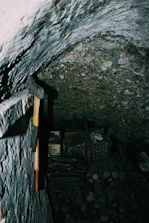 A cozy, dimly lit room with axes and broken dishes ready for throwing activities