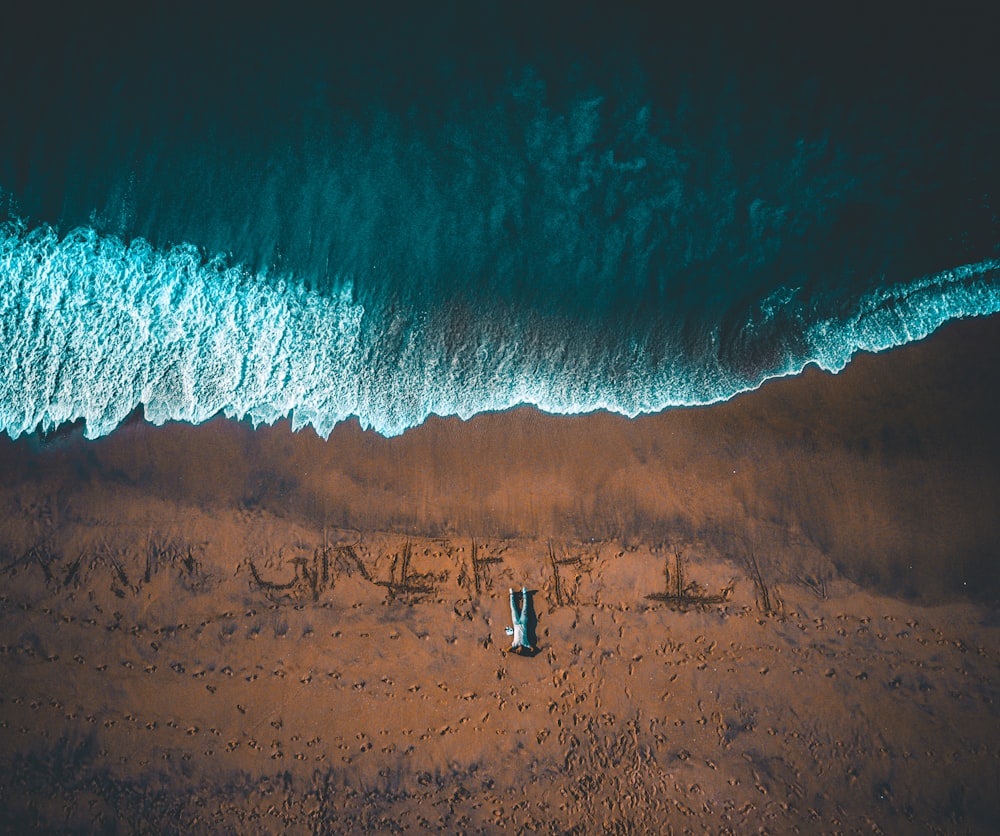 bird's eye view of man lying down on seashore