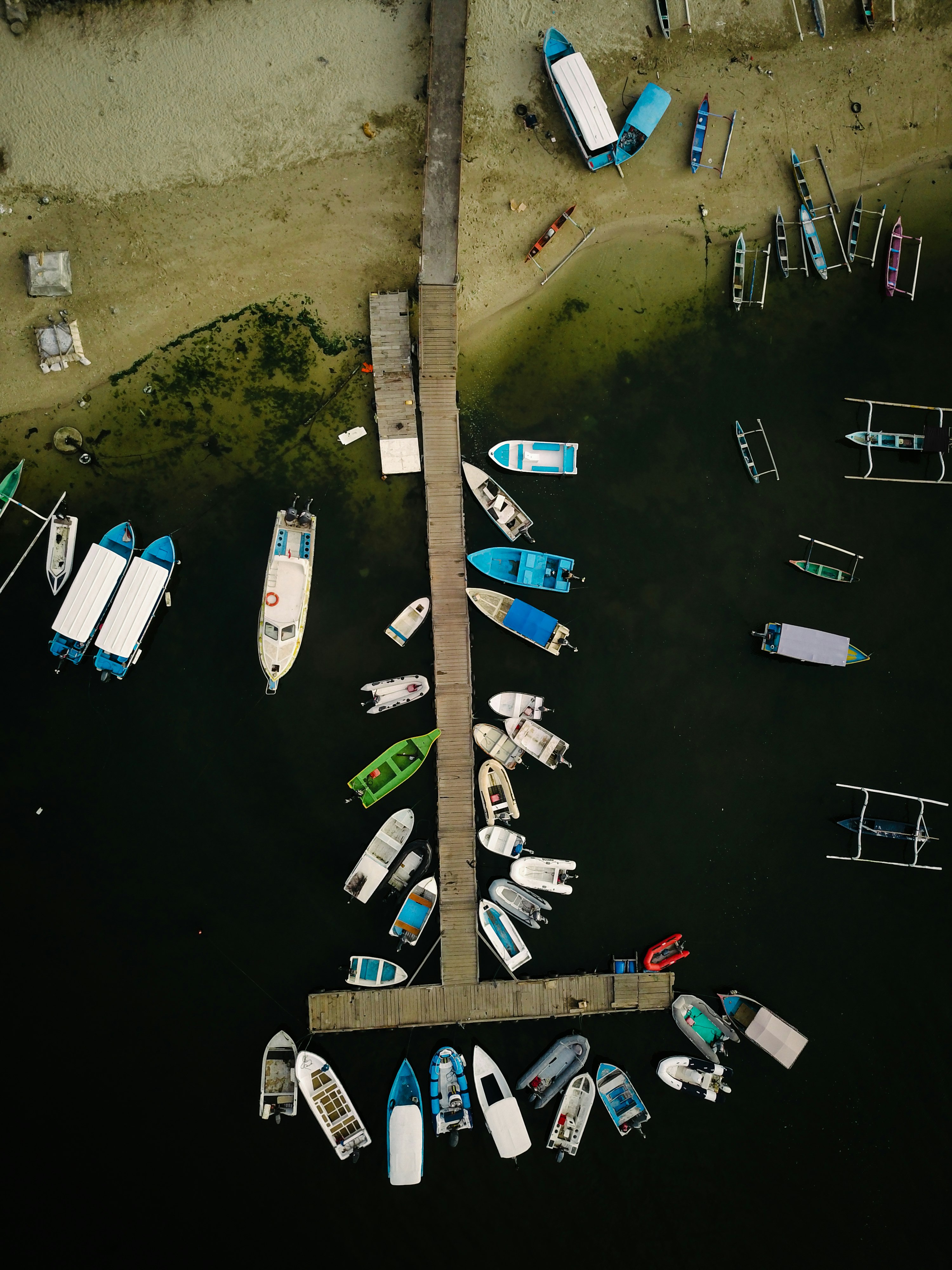 aerial view of motorboats and yachts parked on dock seashore during daytime