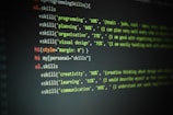 Lines of code are displayed on a dark screen, showing a set of skill percentages related to programming, planning, organization, visual design, creativity, learning, and communication. The text is colored, likely to indicate syntax highlighting in a code editor.
