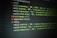 Lines of code are displayed on a dark screen, showing a set of skill percentages related to programming, planning, organization, visual design, creativity, learning, and communication. The text is colored, likely to indicate syntax highlighting in a code editor.
