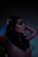 A serene woman meditating with glowing energy around her hands.