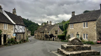 gray brick houses under dark cloudy sky