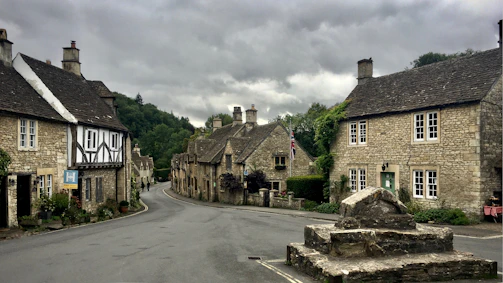gray brick houses under dark cloudy sky
