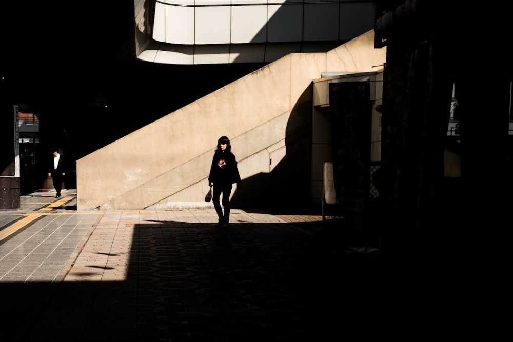 woman standing beside staircase