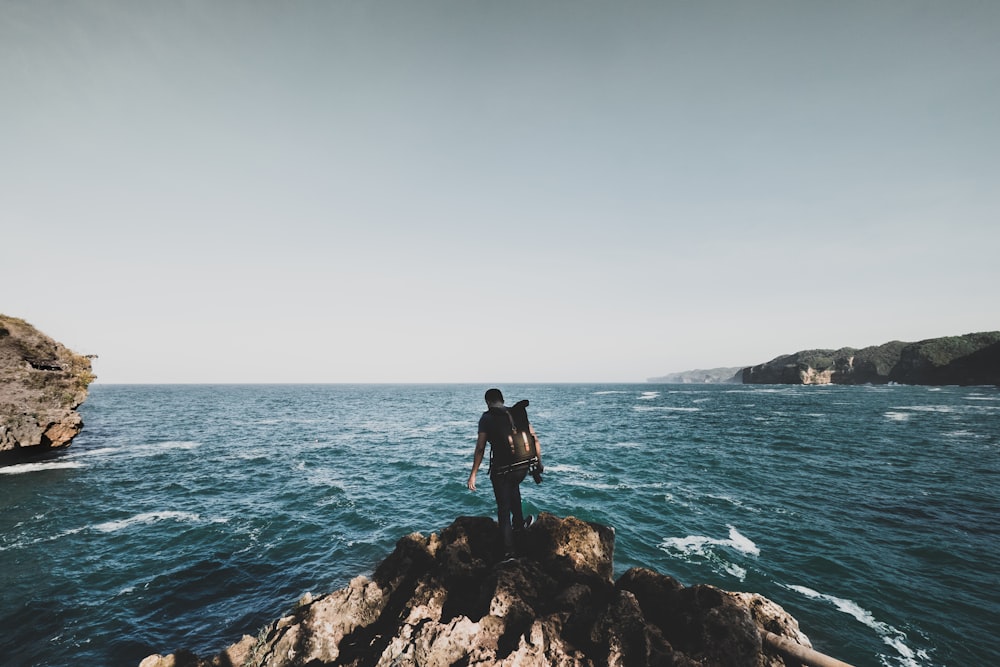 man standing on the cliff