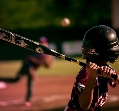 selective focus photography of person holding baseball bat