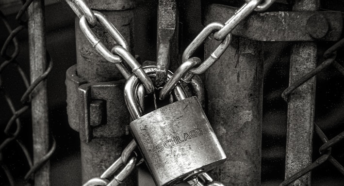 gray steel chain locked on gate