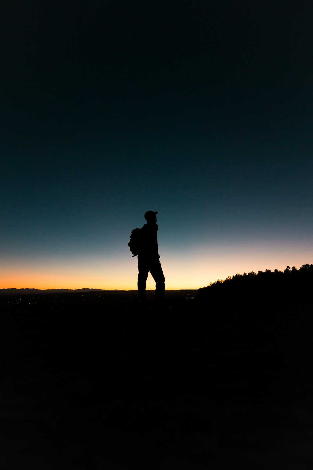 man with backpack in silhouette